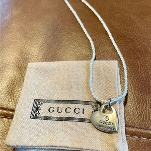 Gucci Silver Heart Charm Necklace with Gucci jewelry pouch.